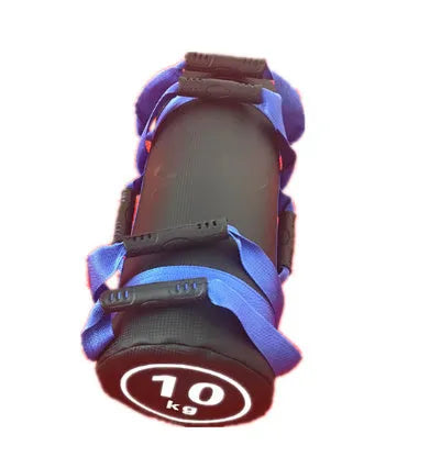 A flat white PVC power lifting sandbag for weight training on a gym floor.