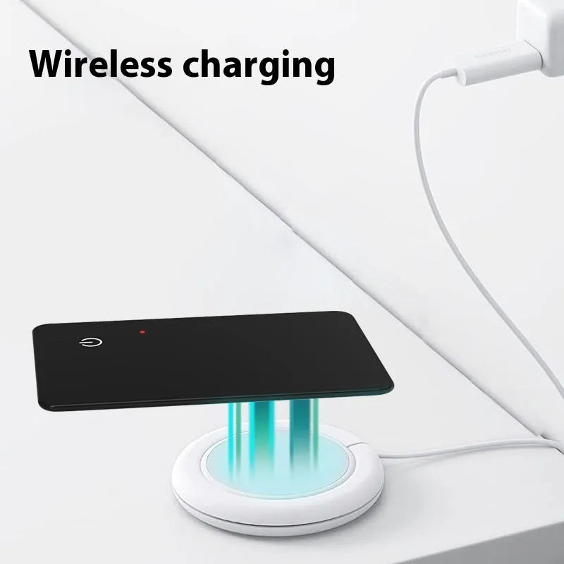 Black credit card-sized pet tracker with wireless charging and a hanging hole, shown next to a coin for scale.