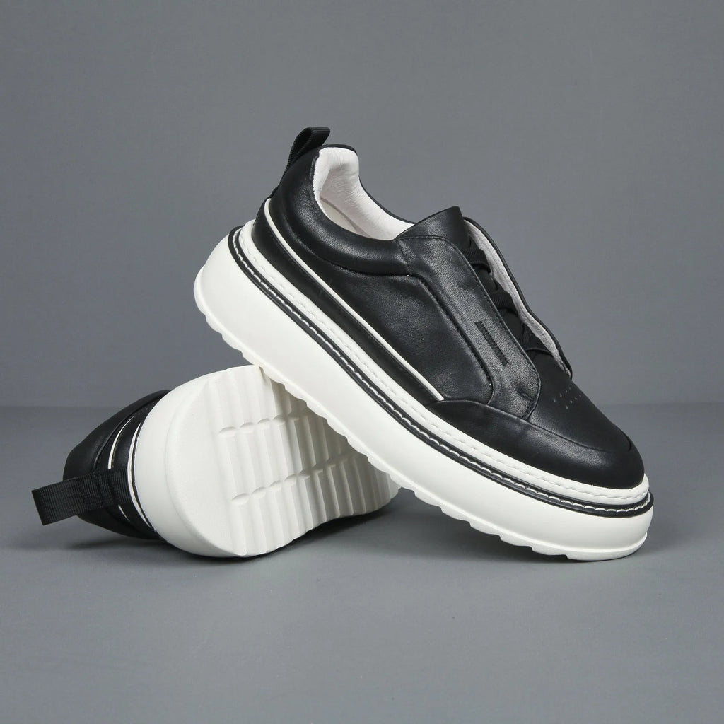 Breathable casual slip-on sneaker in black with first layer cowhide upper, platform mid heel, and sewing thread detail