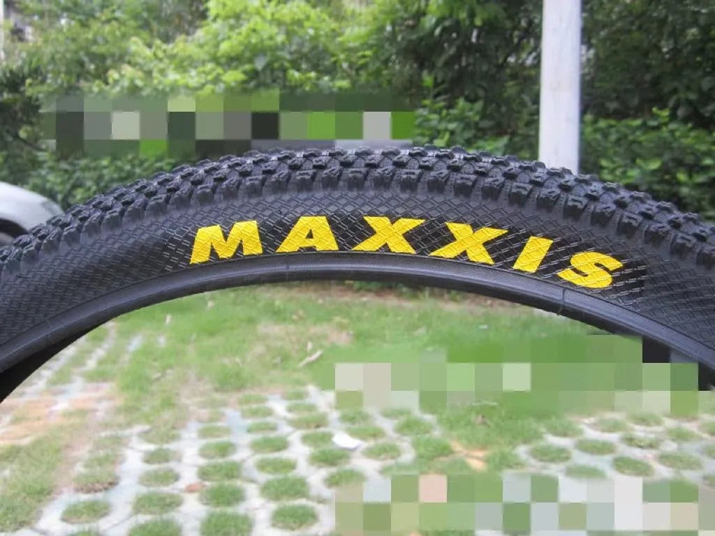 Ultralight mountain bike tyre with reinforced black sidewall shown next to size and weight specifications.