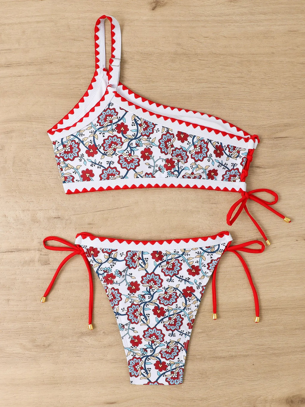 Blue one-shoulder floral bikini for women on a mannequin, front view.