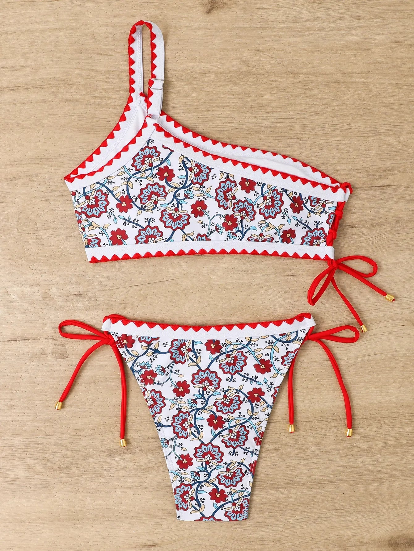 Blue one-shoulder floral bikini for women on a mannequin, front view.