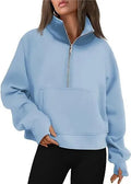 A woman wearing a loose-fitting apricot-coloured fleece-lined sweater with a lapel neckline and raglan sleeves.