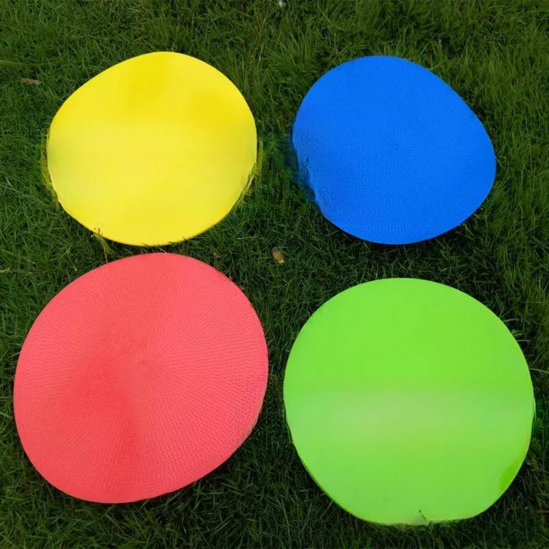 Multi-colour 23 cm diameter soft TPE football training target disc on grass
