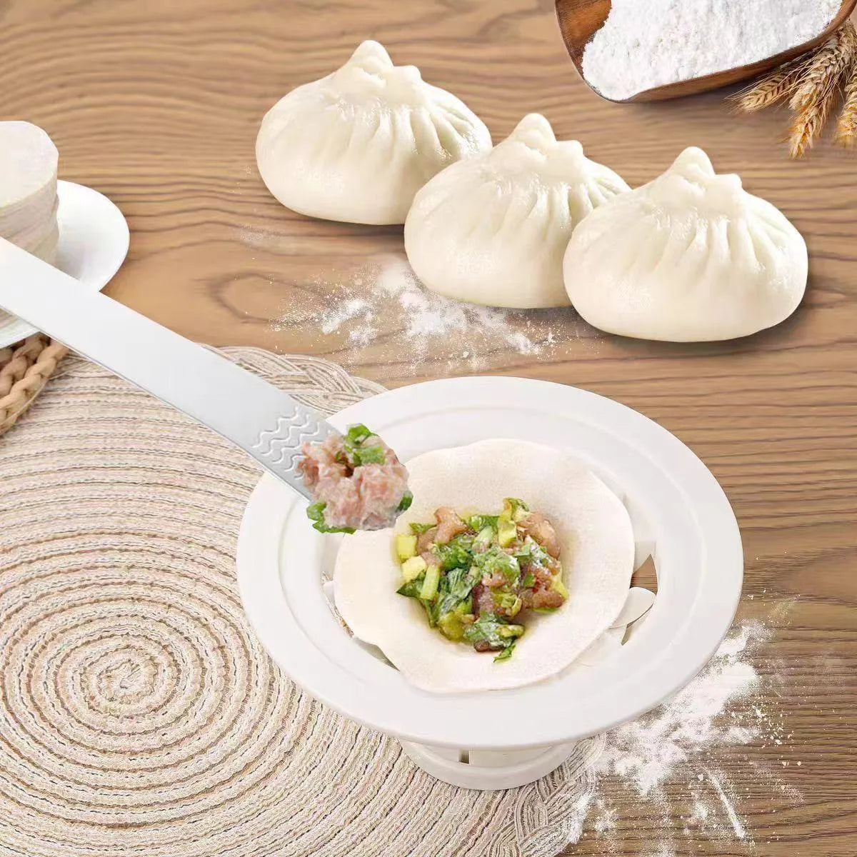 Set of four black plastic baozi and dumpling moulds for shaping steamed buns.