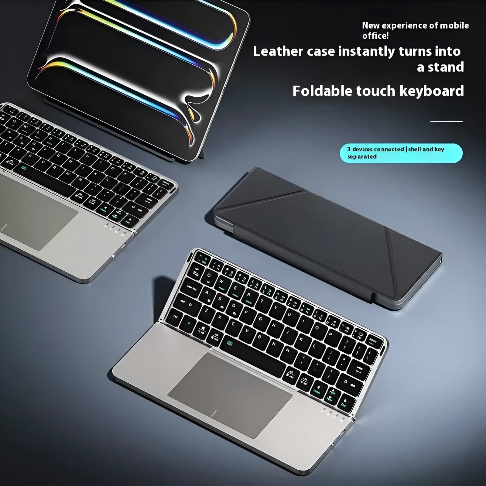 Grey folding Bluetooth keyboard shown open next to a mobile phone.