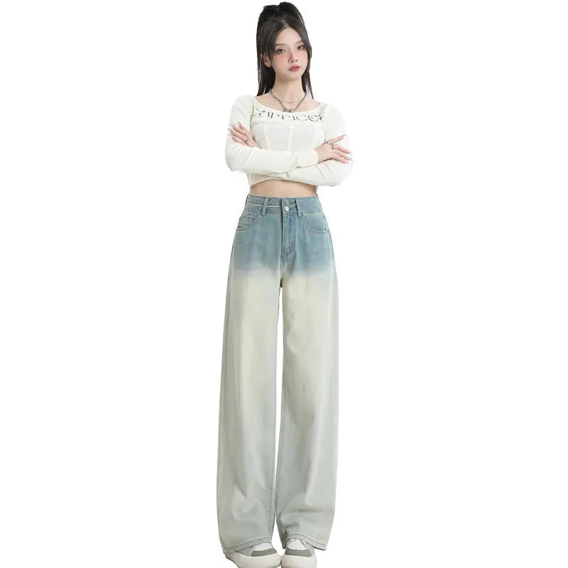 A pair of women's gradient blue wide-leg denim trousers on a neutral background.