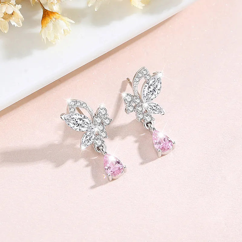 A pair of silver butterfly stud earrings with clear crystals on a white background.