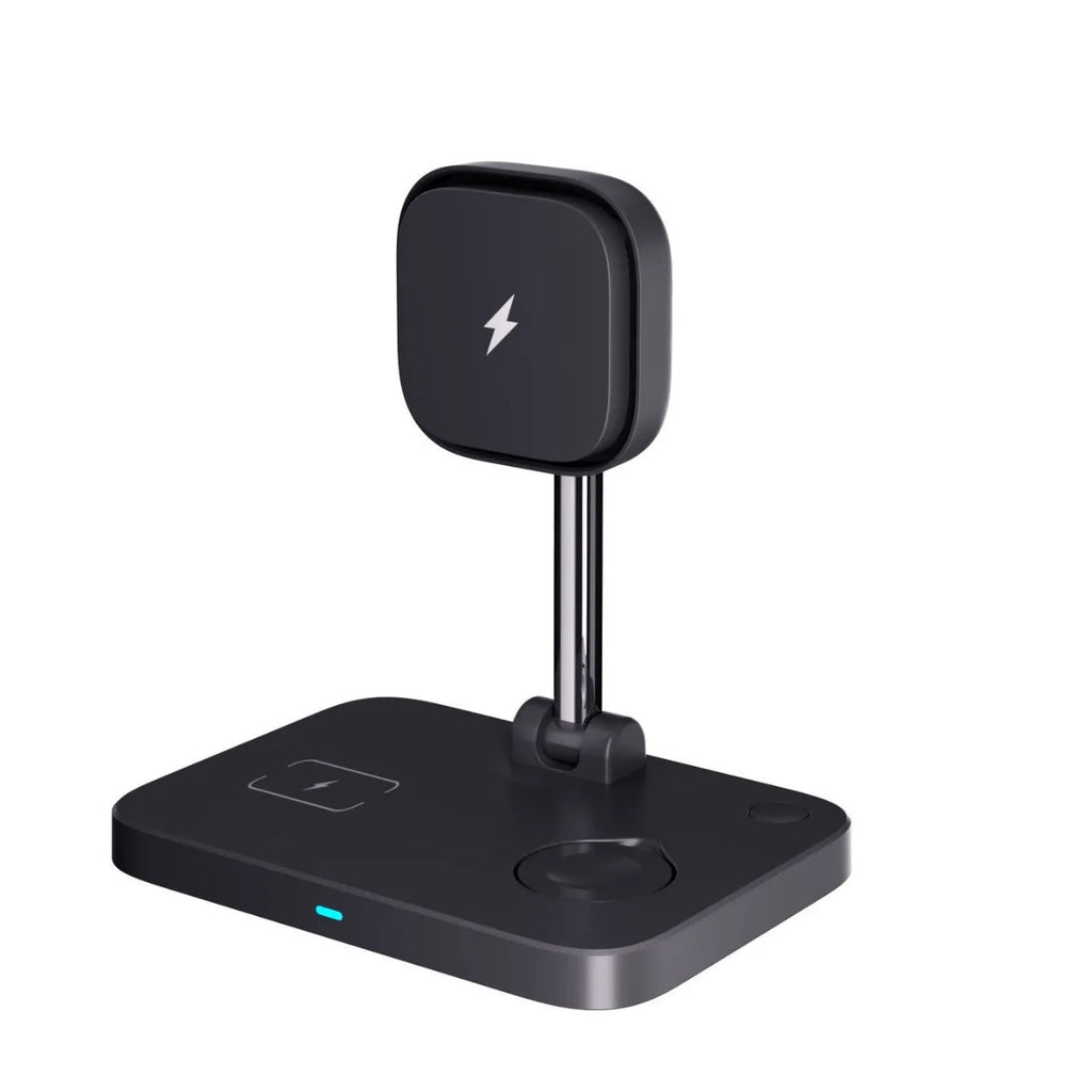 Black magnetic three-in-one wireless charger and cooling bracket on a desk, with phone upright and watch on base.