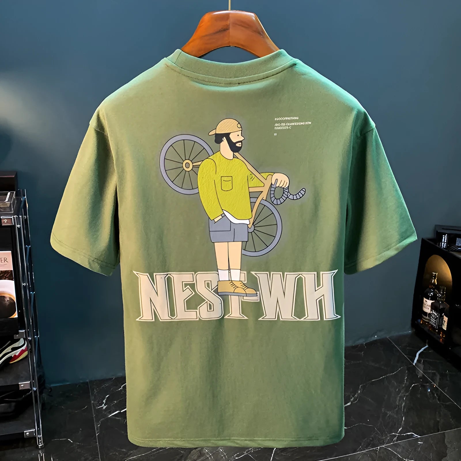 Green men's loose fit printed short sleeve t-shirt on a hanger
