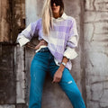 Lilac and white plaid print loose sweater with long sleeves and ribbed trim on cuffs and hem.