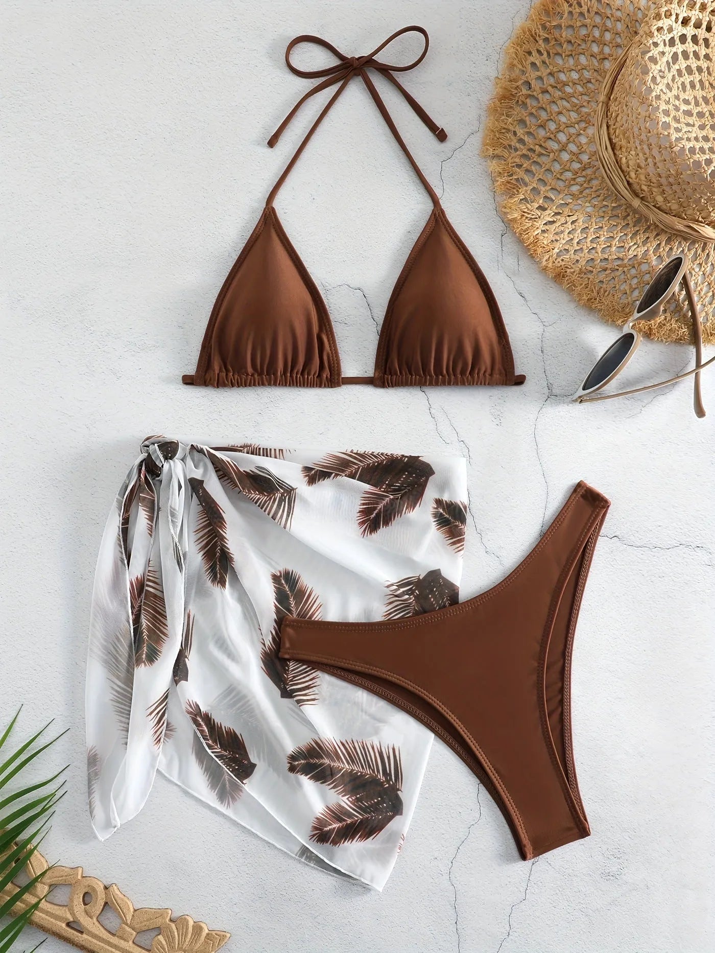 Women's orange three-piece bikini swimsuit set with a matching gauze skirt on a mannequin