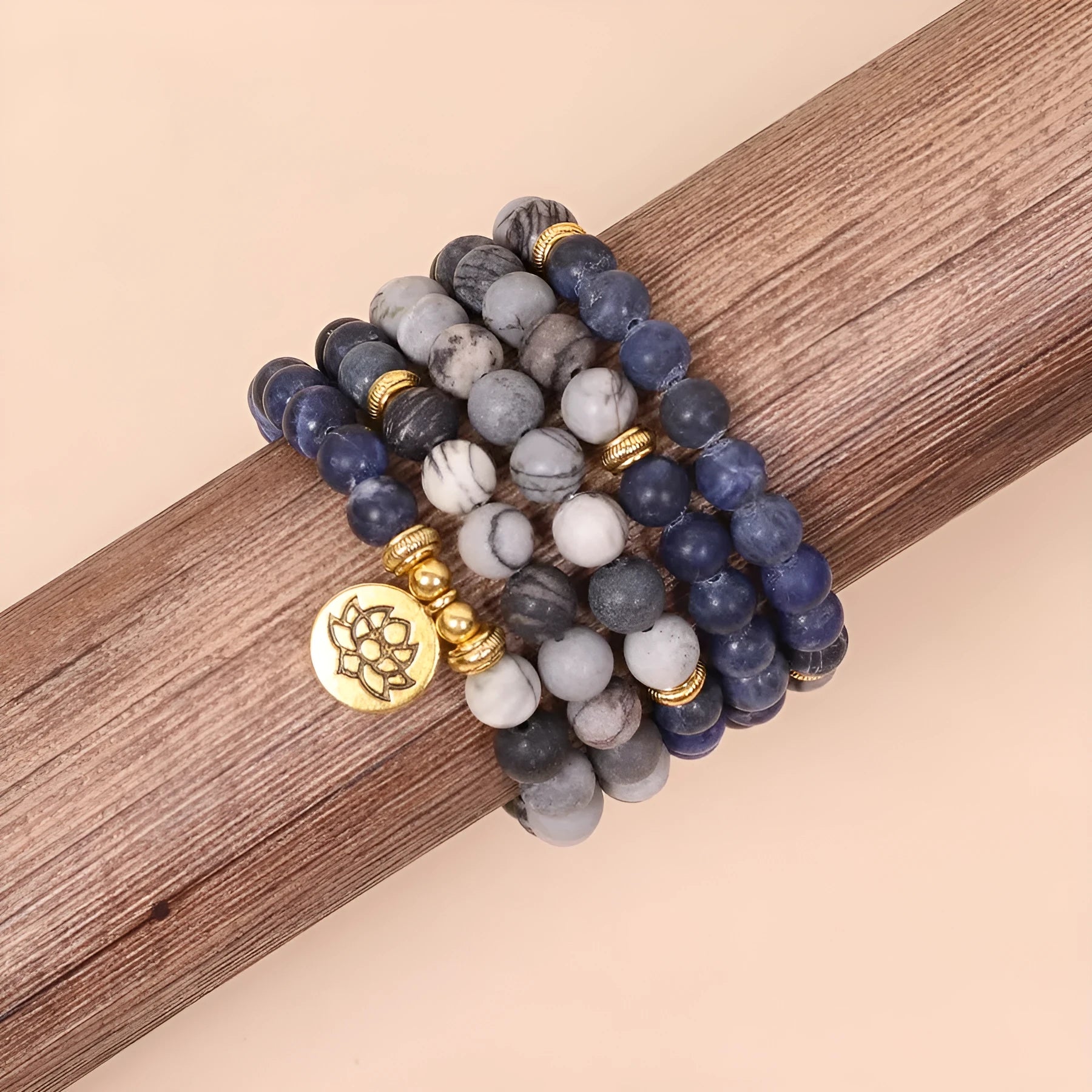 Blue patterned stone bead multi layer alloy bracelet with clasp on a white background.