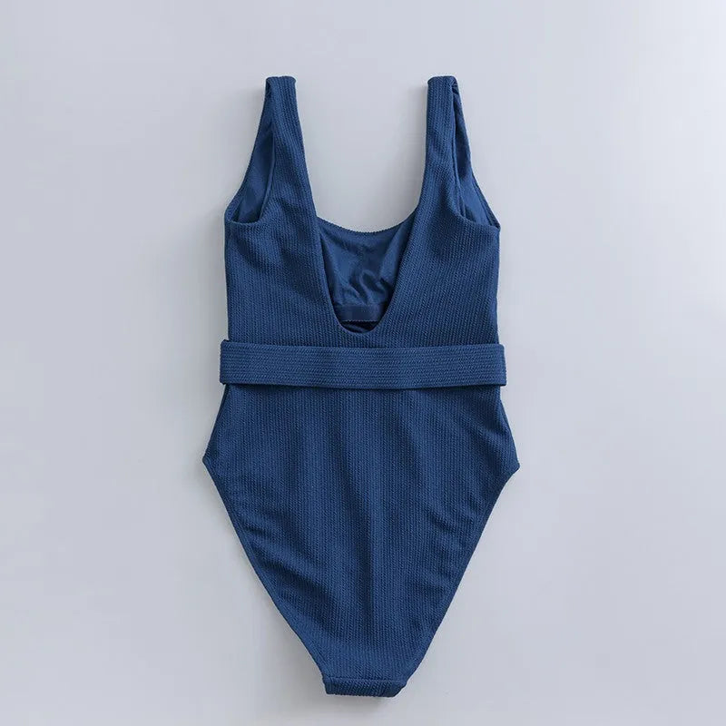 Navy blue women's slim-fit one-piece swimsuit with triangle top and removable padding.