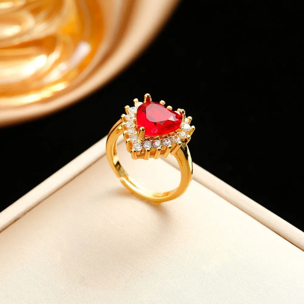 Gold red titanium steel necklace with heart floral pendant and matching stud earrings and ring set.