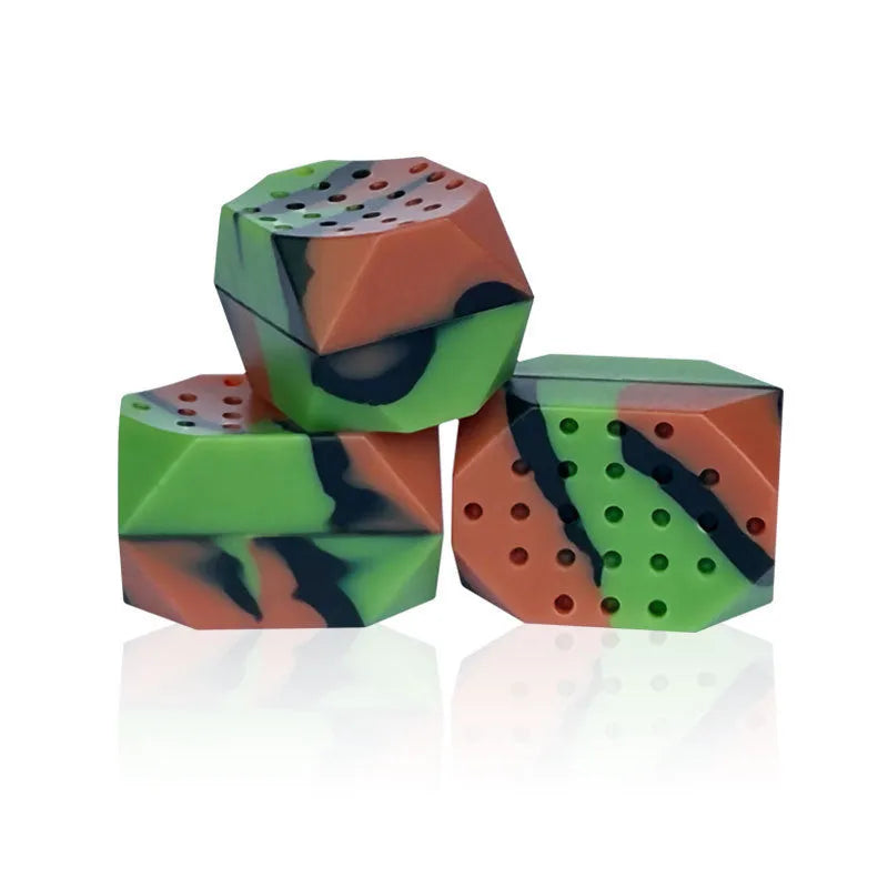 Two camouflage silicone facial muscle fitness balls for jaw training in a transparent box.