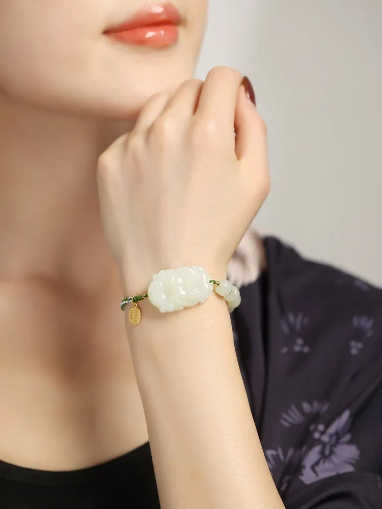 Rabbit Chinese zodiac bracelet with Hetian jade charm and silver card on a red rope.