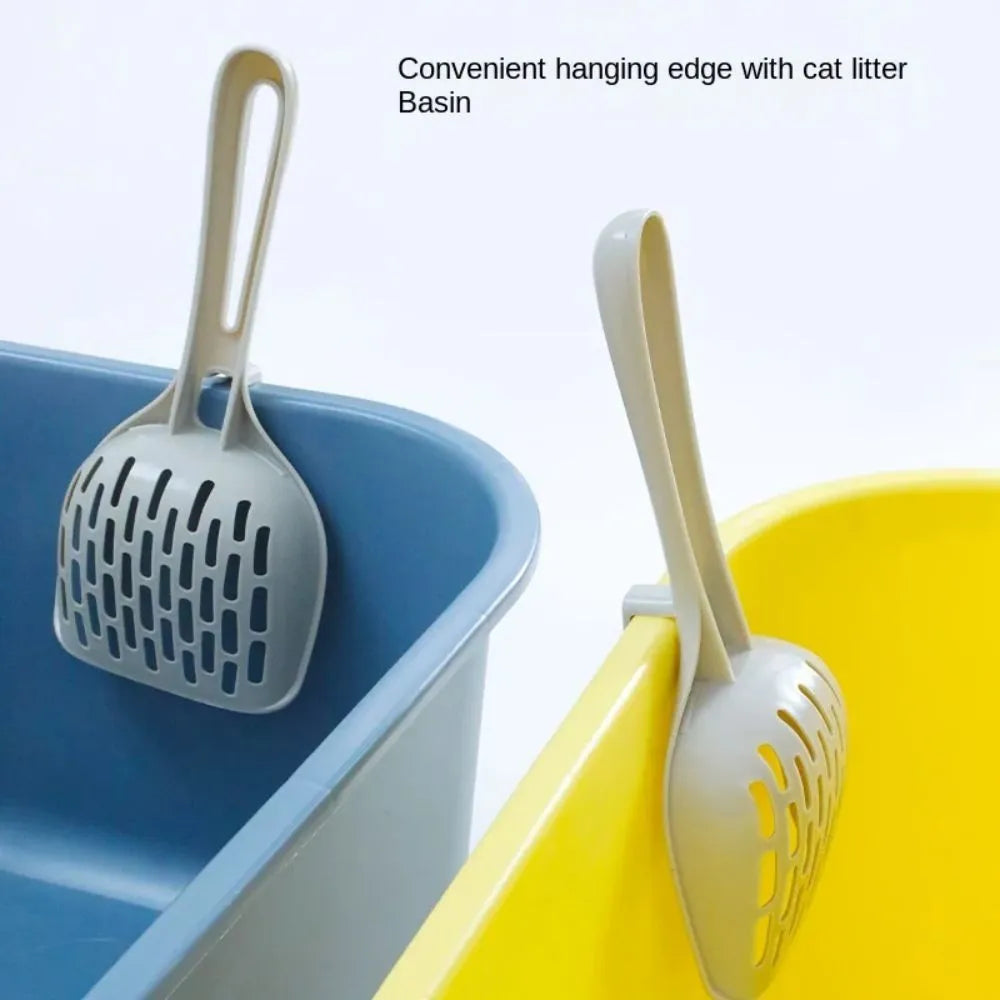 Grey plastic cat litter scoop with base stand showing drainage holes and ergonomic handle