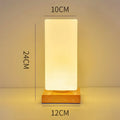 Nordic solid wood USB table lamp in cube shape with touch dimming for bedroom use