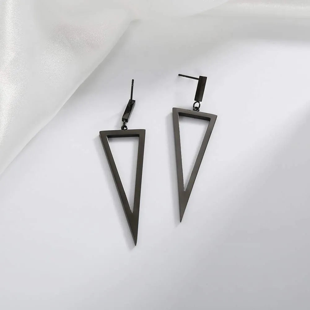 Black metal triangle earrings with electroplated finish on a neutral background