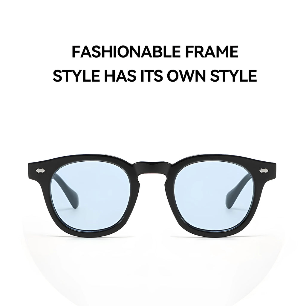 Simple round rim plastic sunglasses on a table showing bright black frame with blue lens.