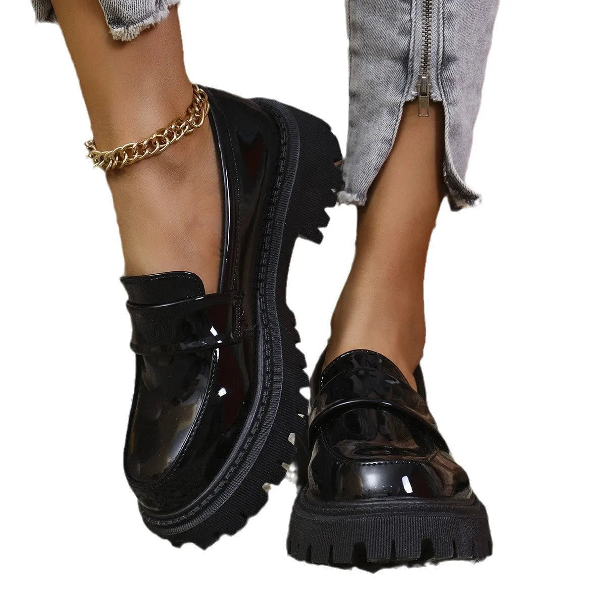Plus size women's black slip-on loafers with a chunky platform heel and thick rubber sole.