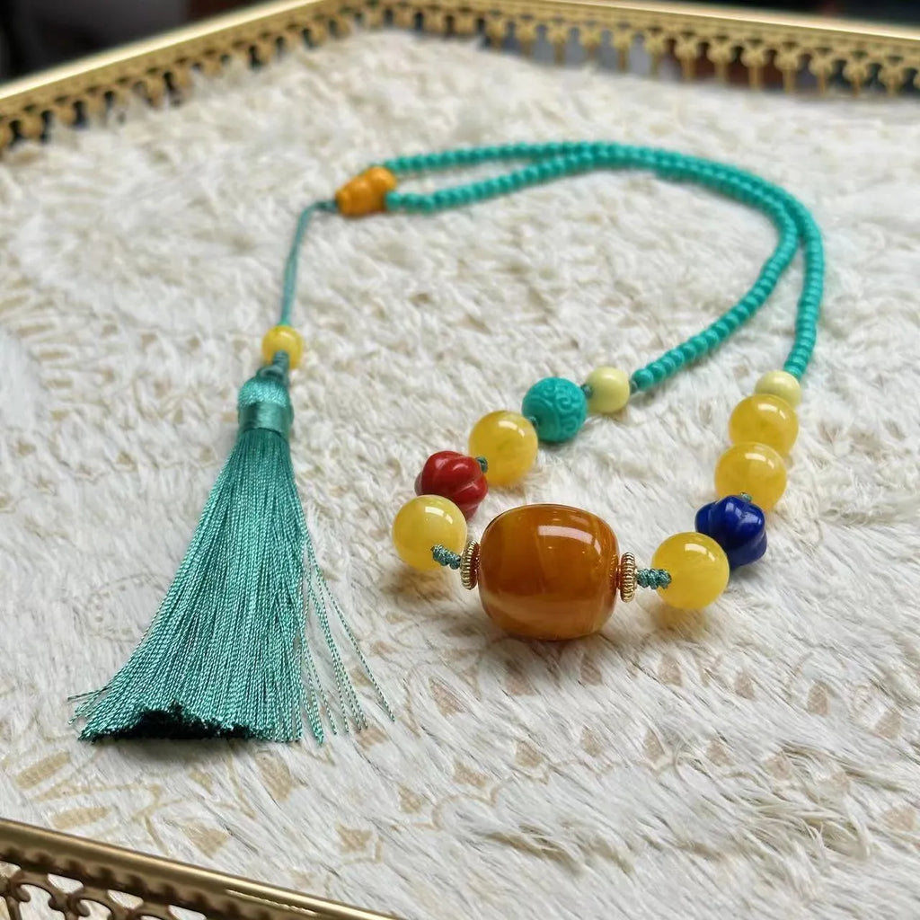 Hand-woven turquoise mesh flower pendant necklace on an adjustable ball bead chain.