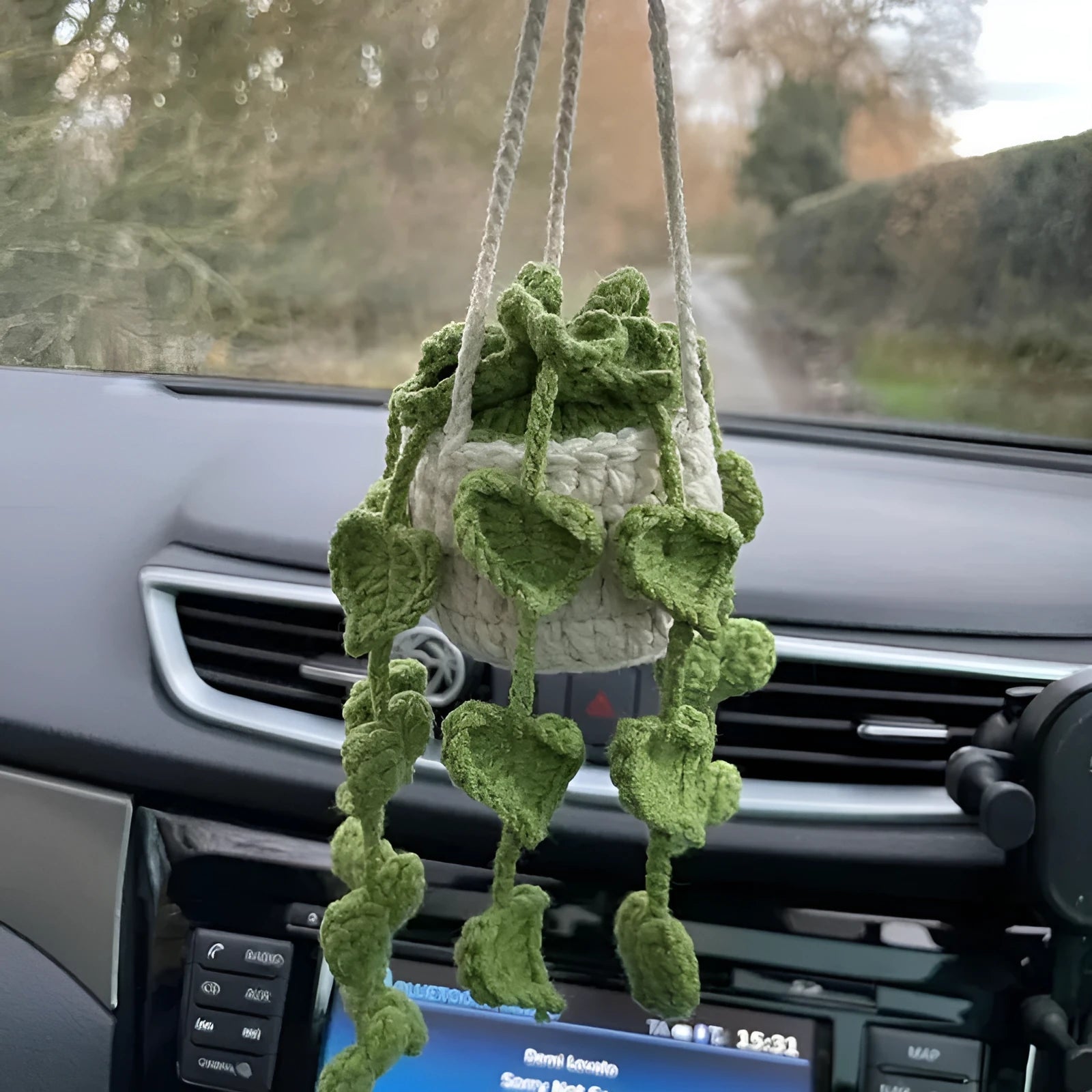 Green and white knitted wool car plant decoration with 8cm base and hanging rope.