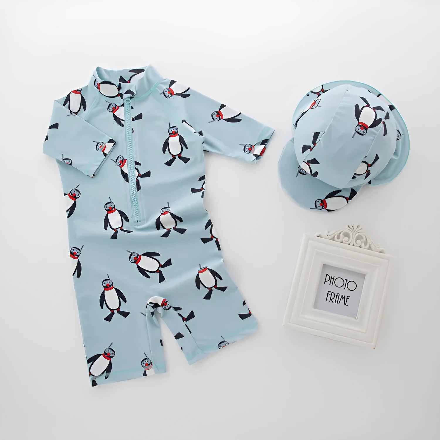Boy's penguin print long sleeve swimsuit one-piece with matching swim cap for sun protection