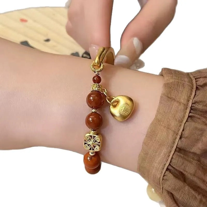 Golden south red agate character ingot bracelet with lucky bag charm design for women
