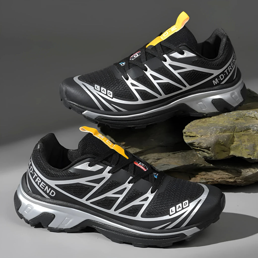 Low-top lace-up hiking shoe in khaki with a rubber sole and mesh lining detail.