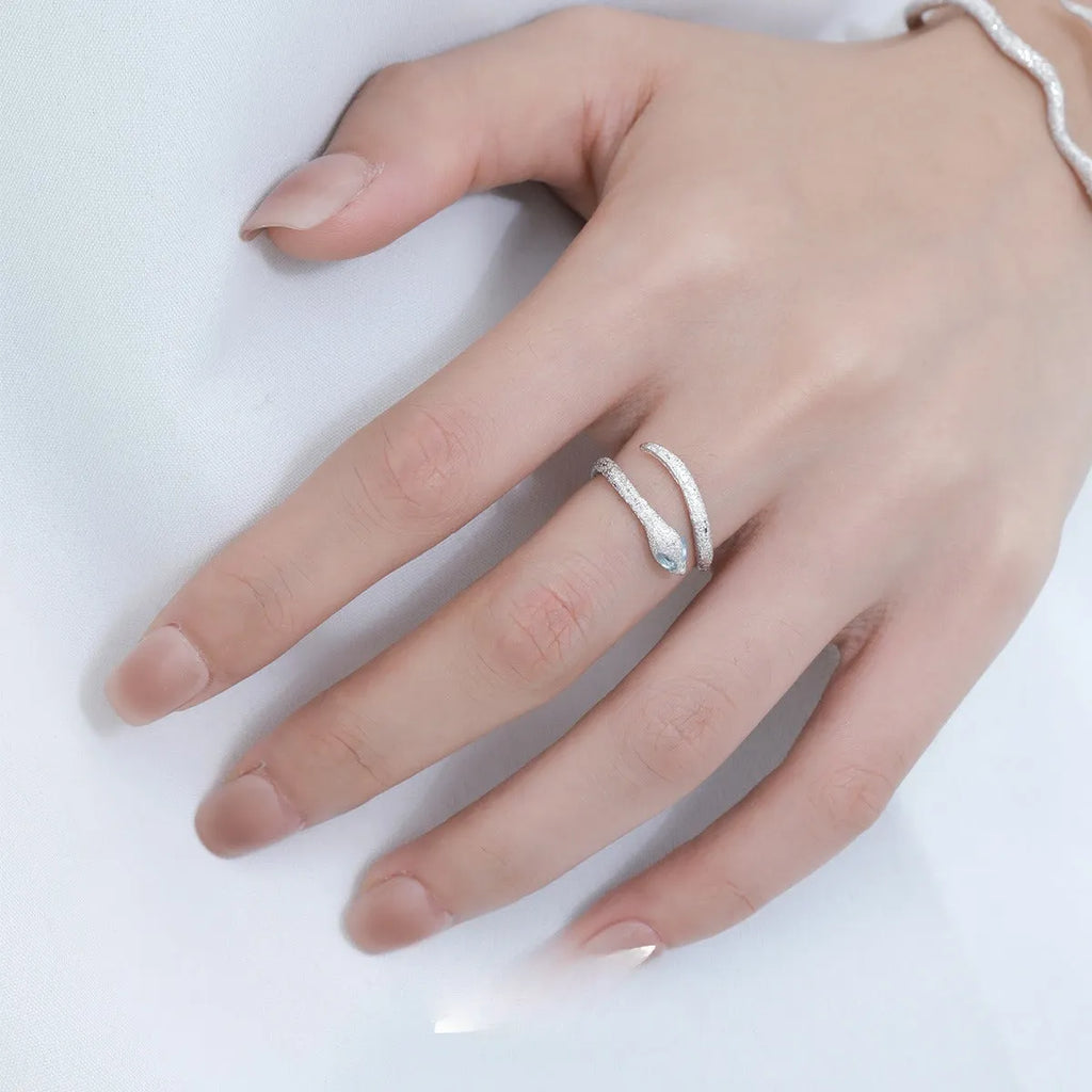 Adjustable silver snake ring with electroplated white gold finish and zodiac design