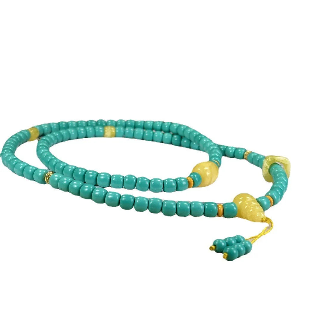 Hand-woven turquoise mesh flower pendant necklace on an adjustable ball bead chain.