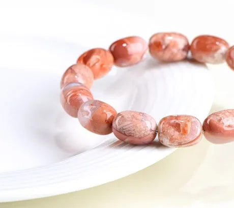 Original design agate bracelet with cherry blossom colour barrel beads and Ruyi charm.