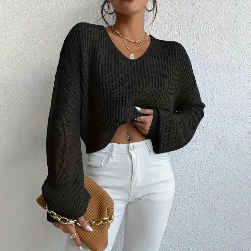 Woman wearing a solid colour long sleeve loose fit casual polyester pullover.
