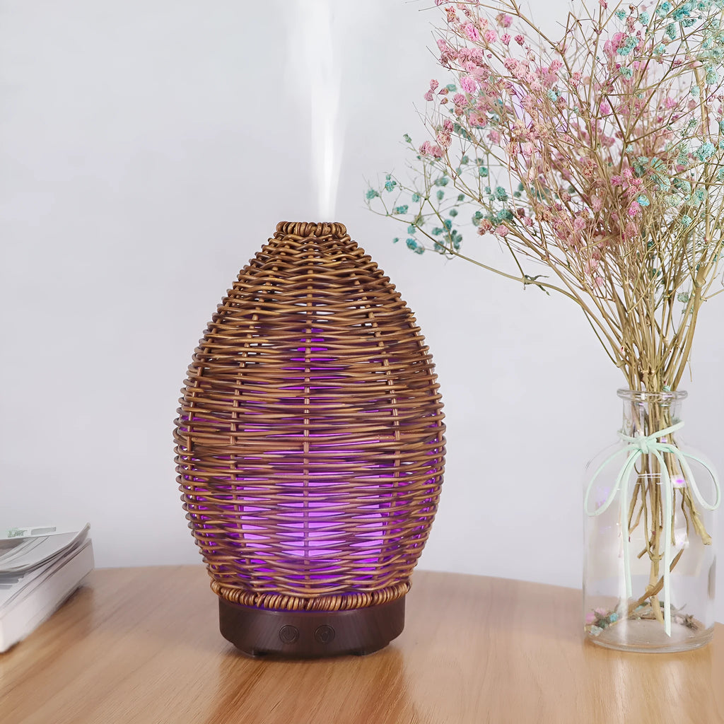 Hollow rattan design aroma diffuser with light wood grain base and 100ml capacity