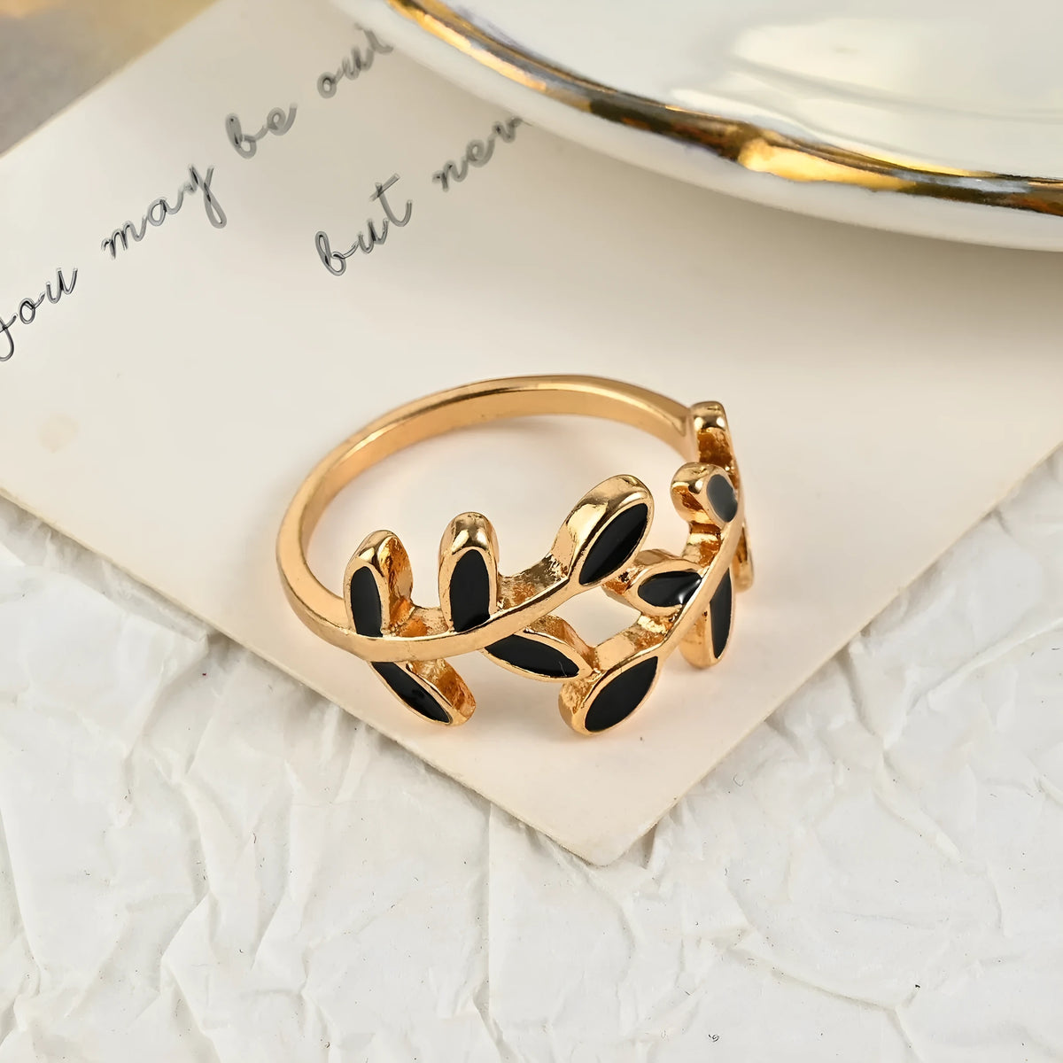 Gold coloured acrylic ring with leaf and flower shape and electroplated finish for women