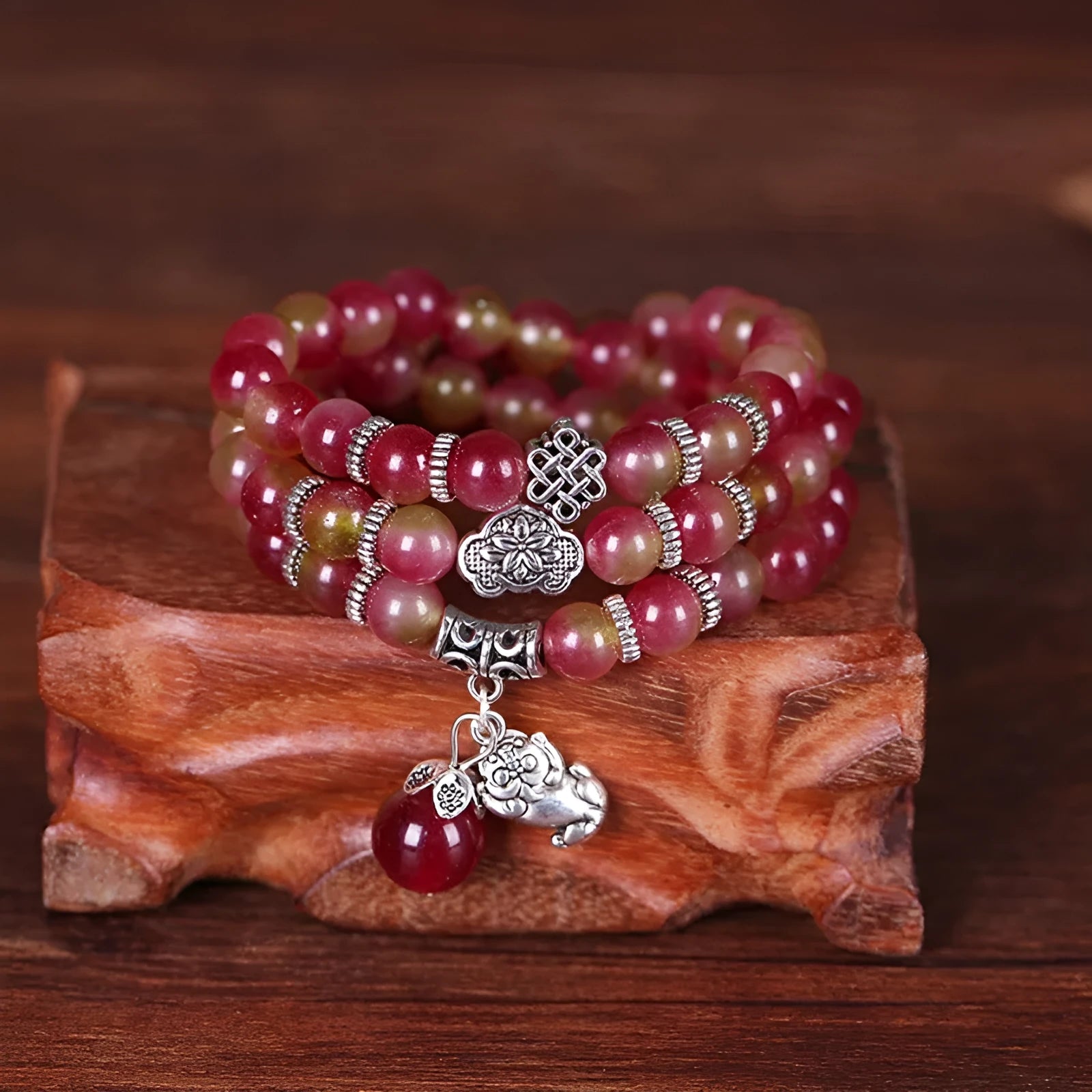 Watermelon crystal bracelet with Chinese knot design showing elephant style beads in geometric shape