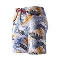 Men's cropped beach swimming trunks in a multicolour leaf pattern, briefs style