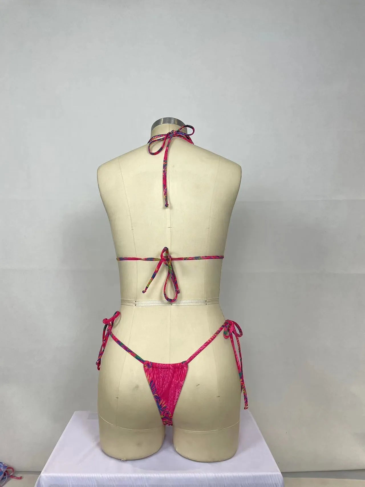 Pink women's bikini two-piece set with printed pattern on nylon fabric.