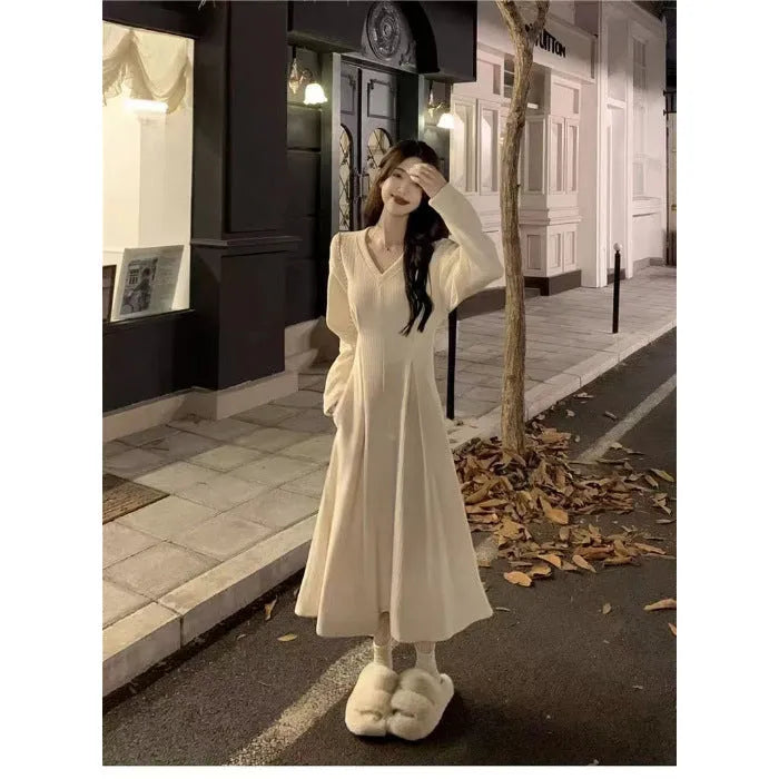 Women's white V-neck knitted dress with long princess sleeves and suspender skirt silhouette