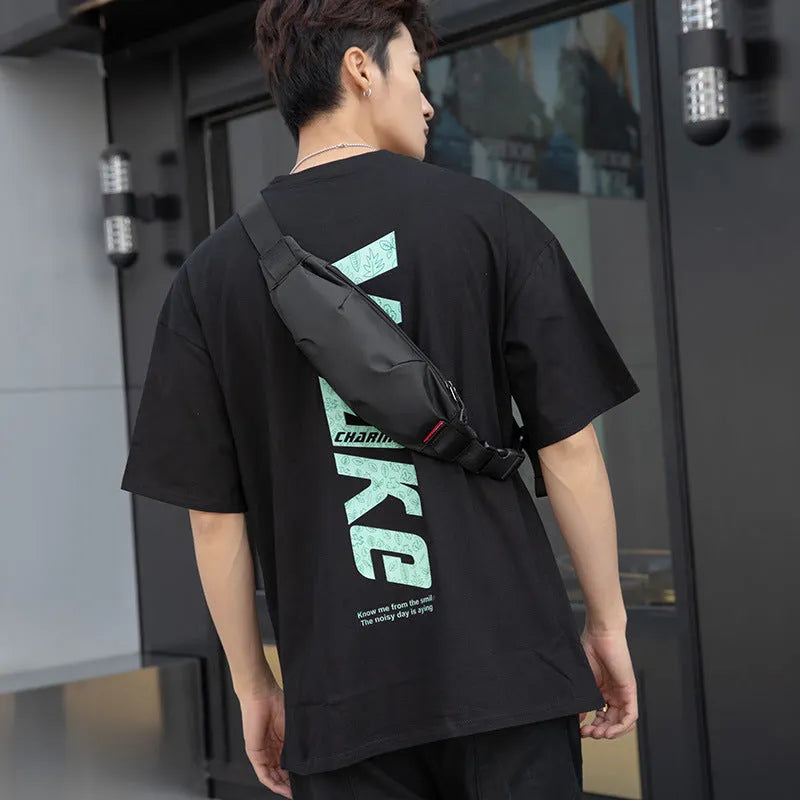 Black Oxford cloth men's crossbody waist pack showing front zipper and interior organisation pockets.