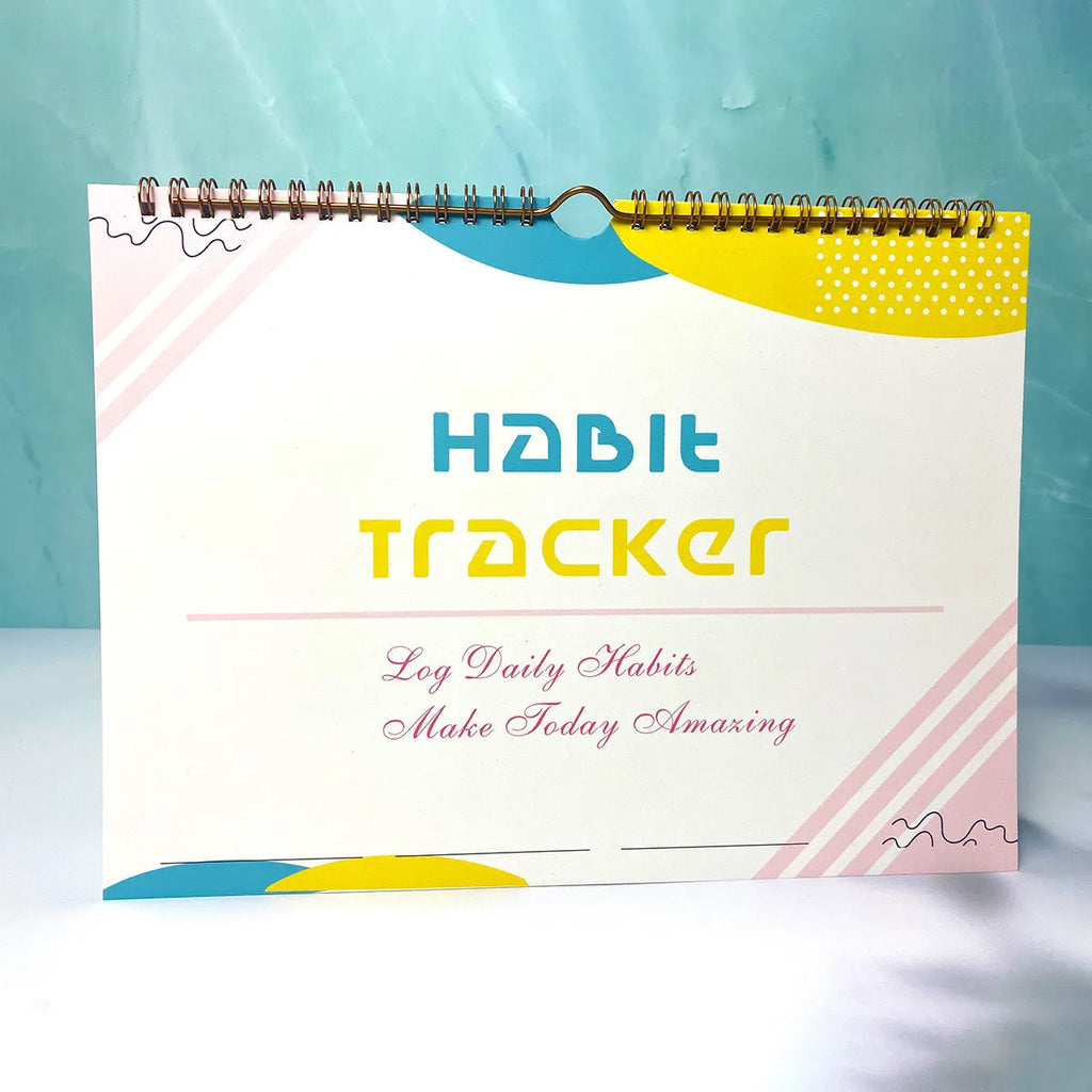 A4 habit tracking book with coloured cover open to show interior pages
