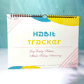 A4 habit tracking book with coloured cover open to show interior pages
