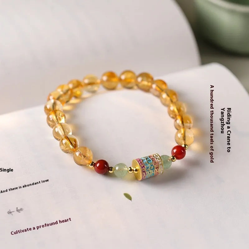 Yellow citrine bracelet with prayer wheel charms and 8mm round beads