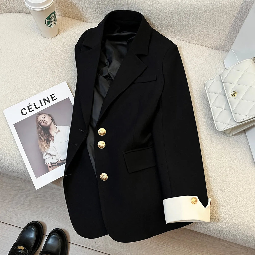 Milky white loose-fit mid-length women's coat with long sleeves and pockets on a hanger.