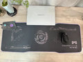 Large black gaming mouse pad with luminous edge lighting on a desk.