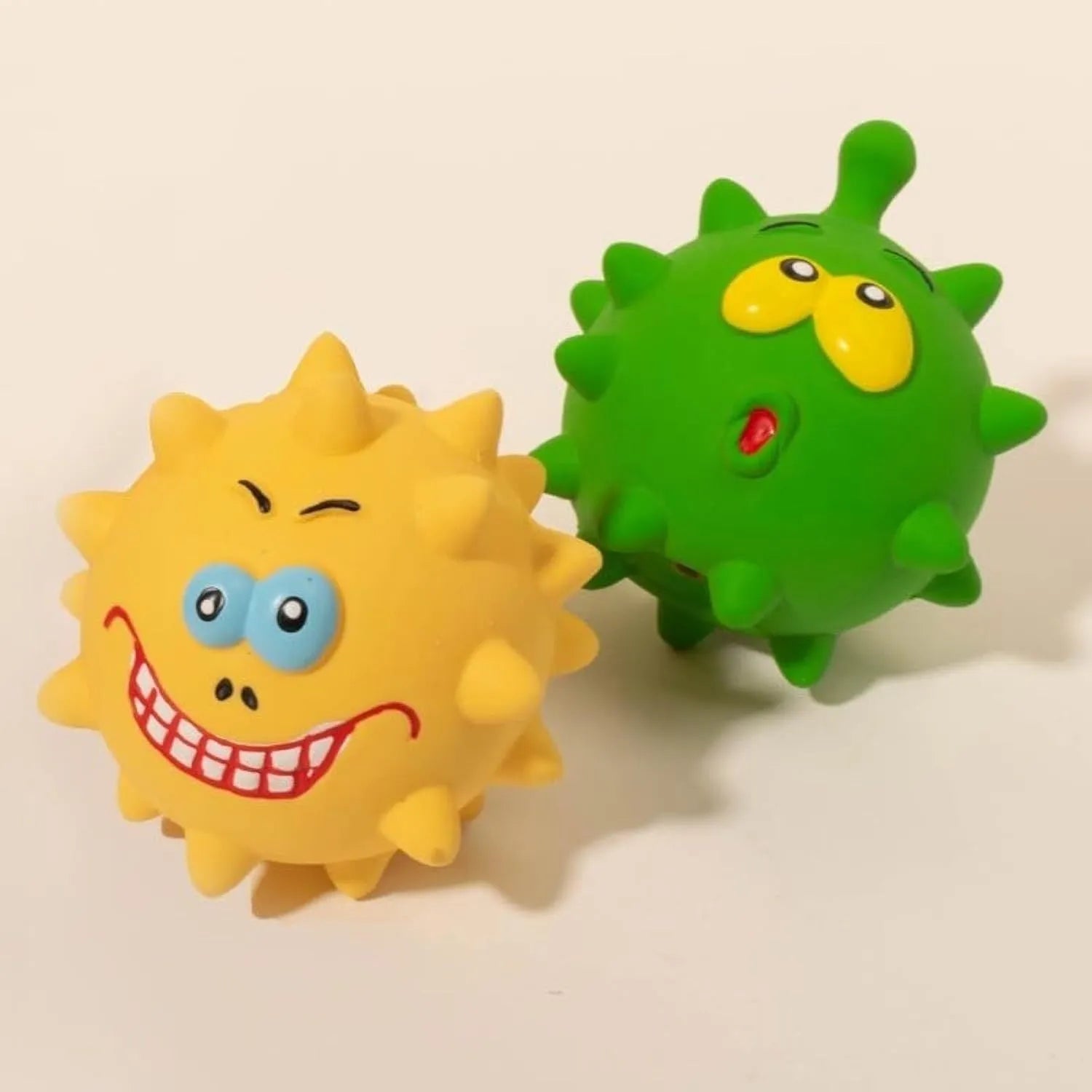 Four colourful latex squeaky dog balls with cute faces, each 7.5cm diameter