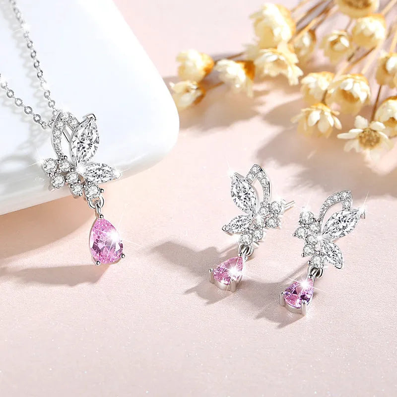 A pair of silver butterfly stud earrings with clear crystals on a white background.