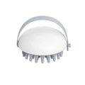 Blue silicone pet bathing brush with soft bristles and ergonomic handle for cats and dogs.